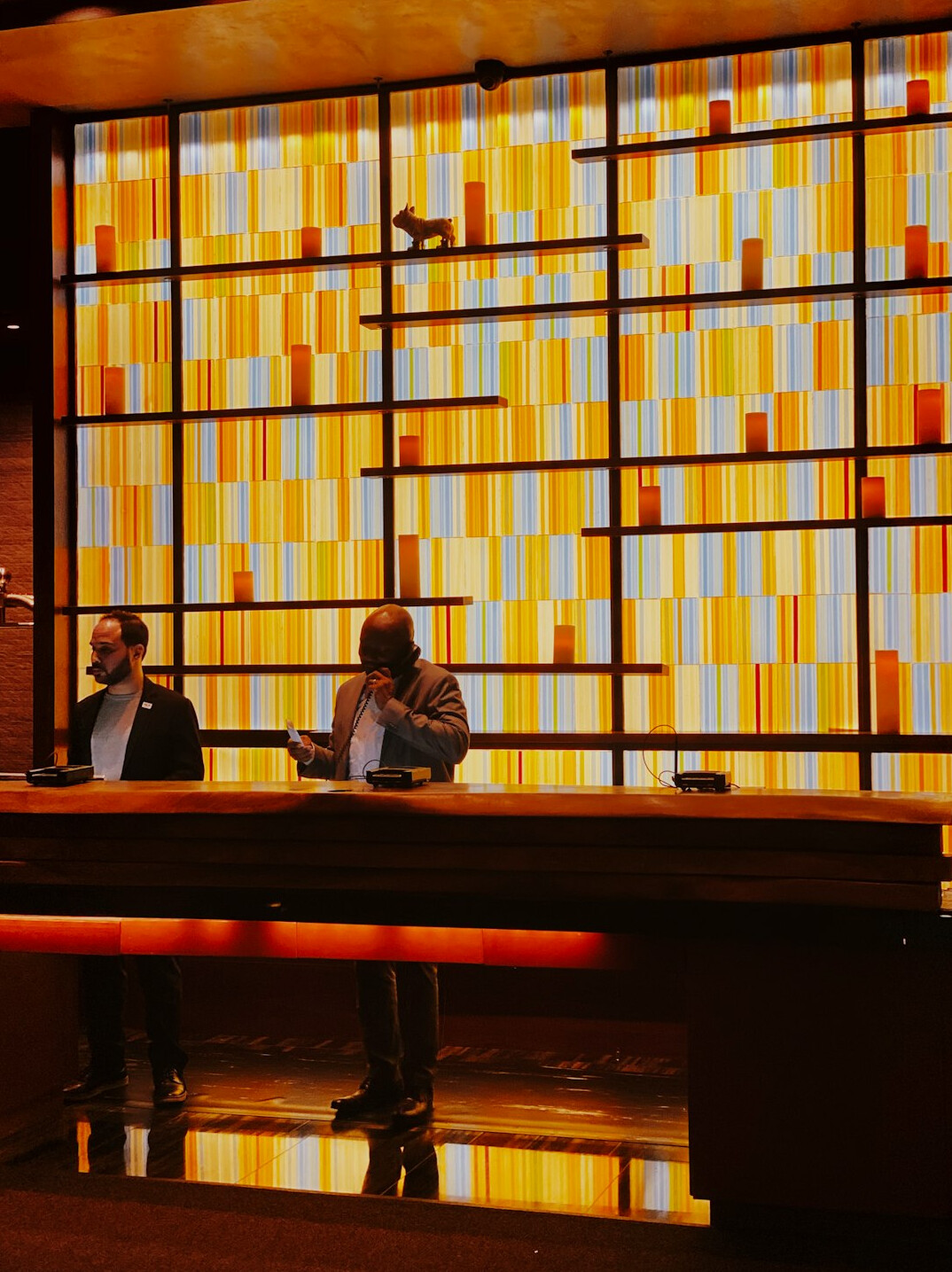 Two news anchors having a heated discussion at a TV studio desk during live broadcast